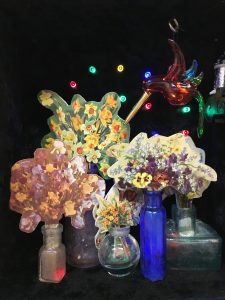 Spring flowers are waning, 2017, 35x22x17, repurposed wooden box, velvet, glass bottles, paper on wood, wind up music box, old glass figurine, repuposed doily, wool, LED lights
